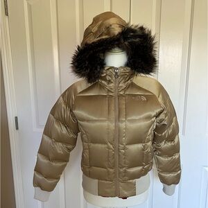 The North Face Women’s goose down bomber jacket. Gold satin finish exterior